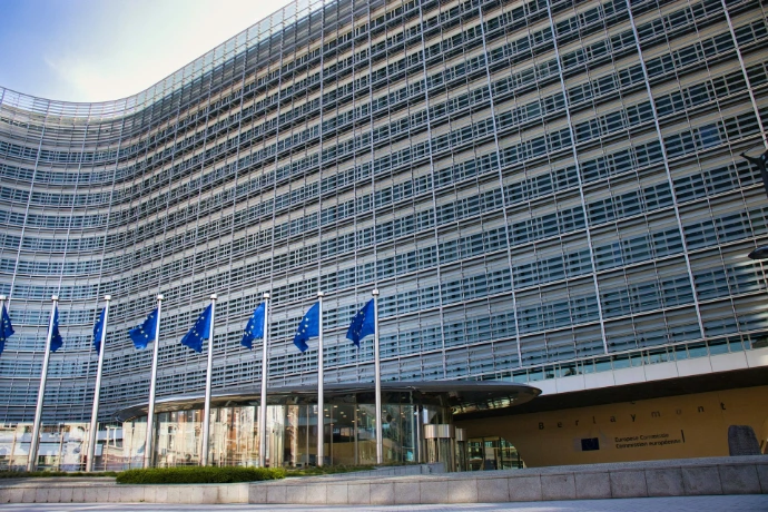 Modern glass building with european union flags